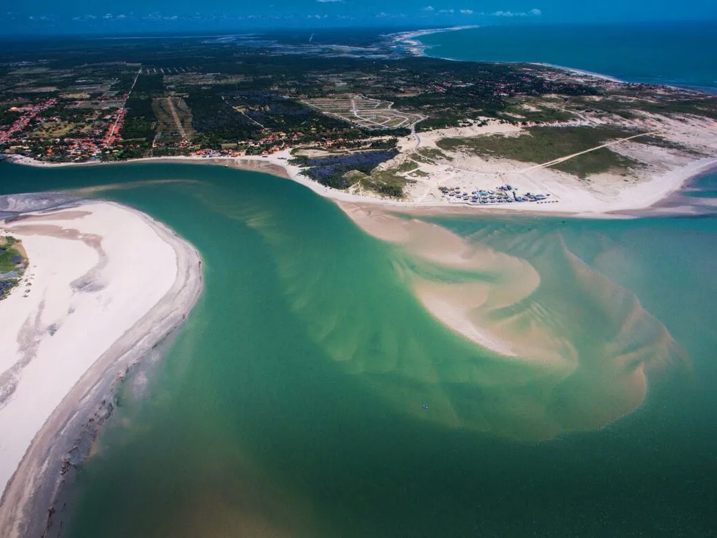 Aerial view of the river mouth with sandbanks and green water